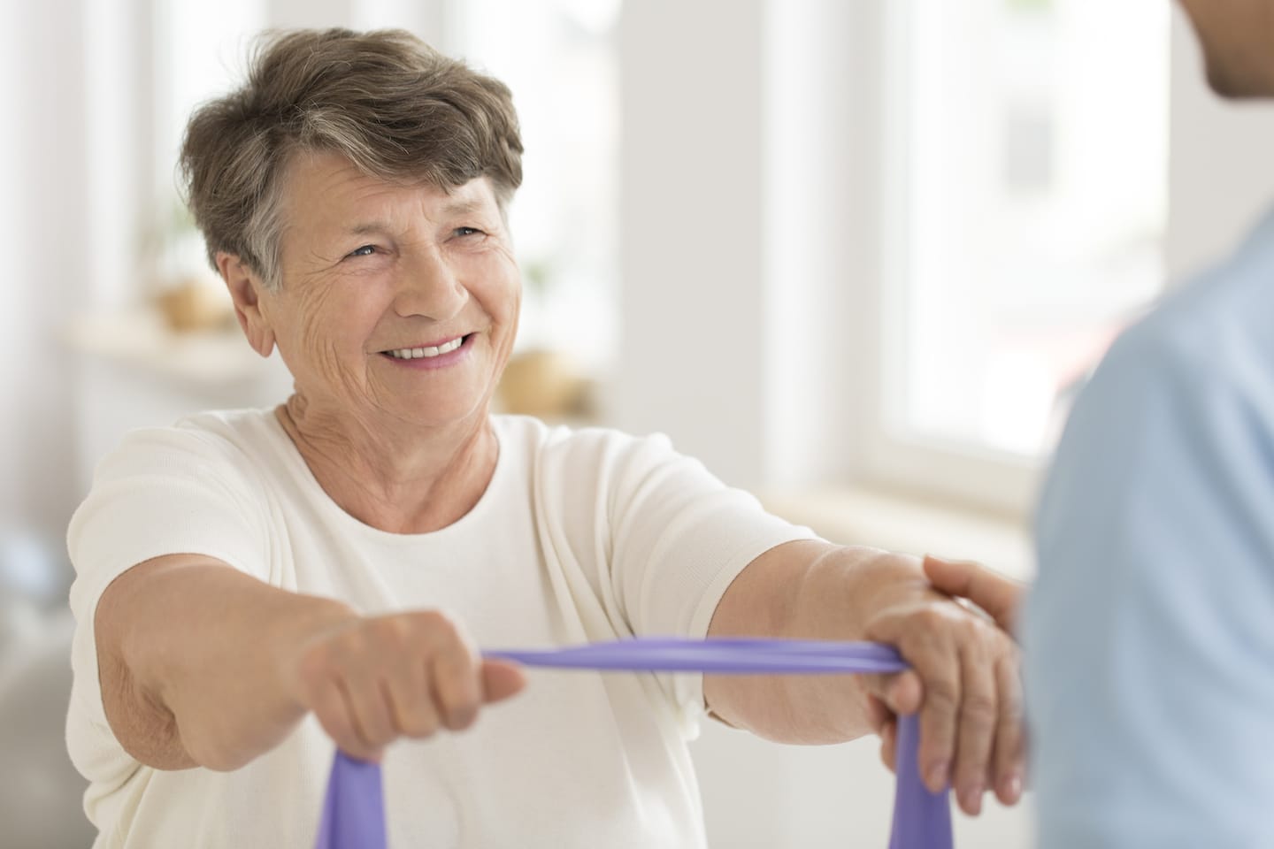 elderly-woman-using-resistance-band-to-stretch-arms