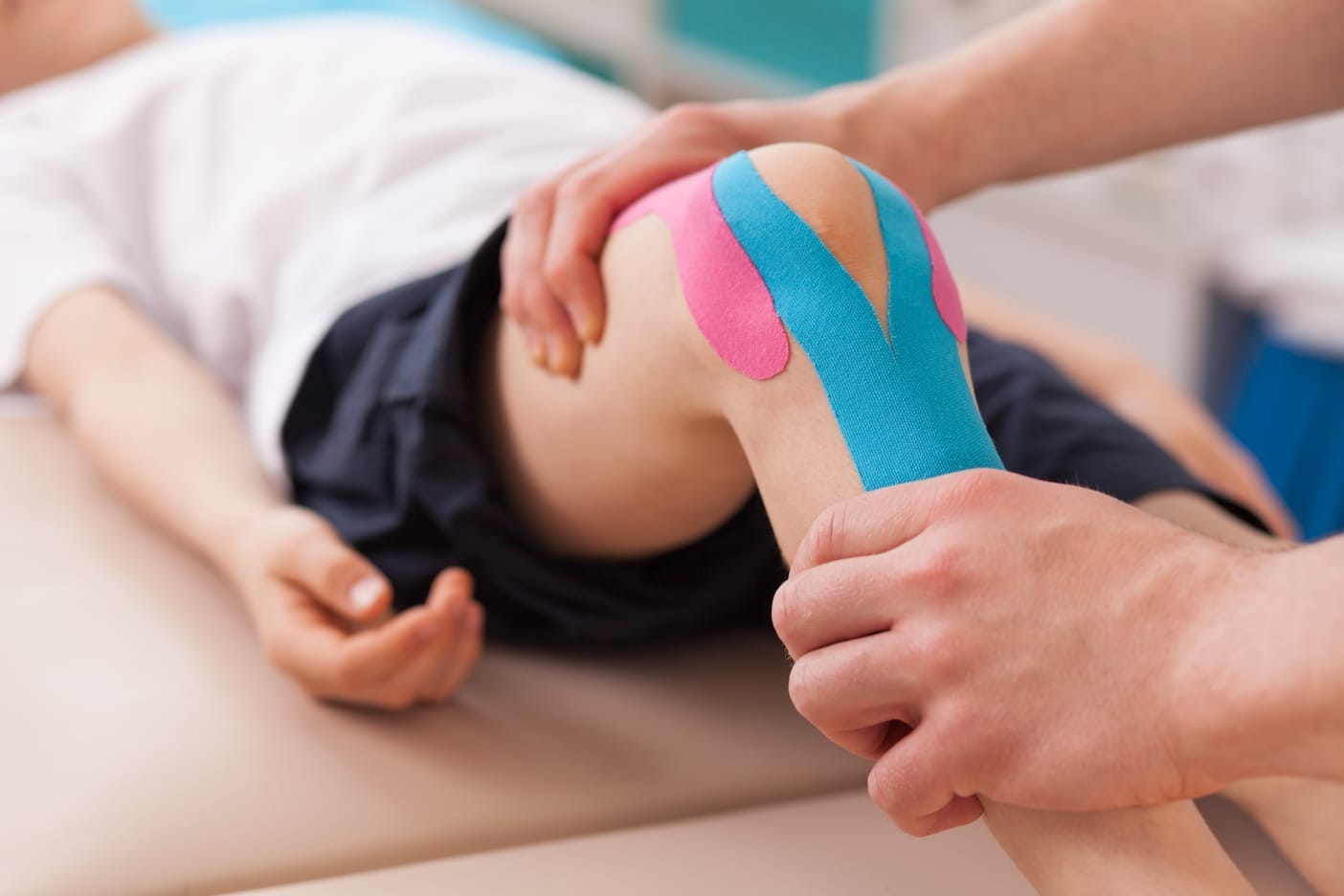 kids-knee-with-physio-tape-supporting-knee